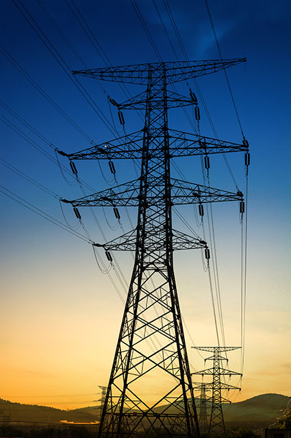 sun setting silhouette electricity pylons